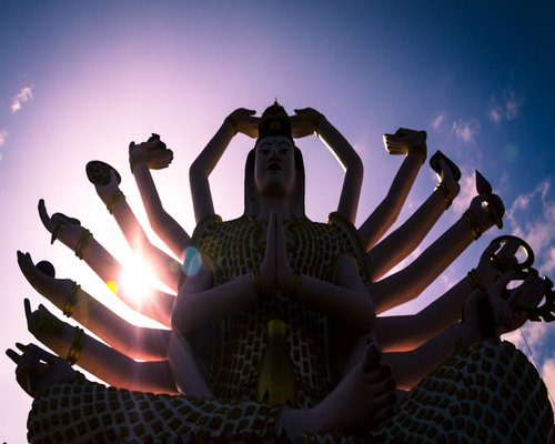 Woman mediating in lotus position at sunset